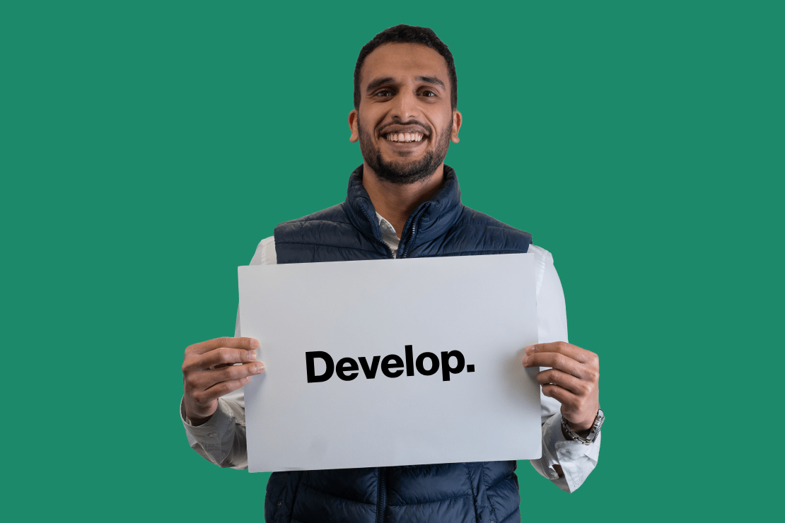 Innoval team member holding a sign that says 'Develop'